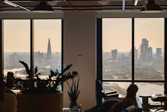 The London skyline and River Thames seen through the windows of a high-rise lounge